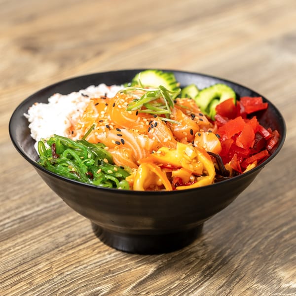 A vibrant Sushi Hana poke bowl with salmon, rice, seaweed, cucumbers, and red peppers.